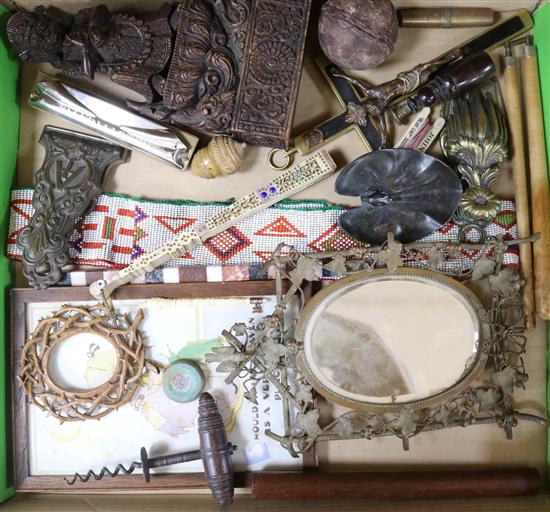 A group of assorted curios including two desk clips, a corkscrew and a bone fan